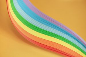 Beautiful rainbow color ribbon on orange background.