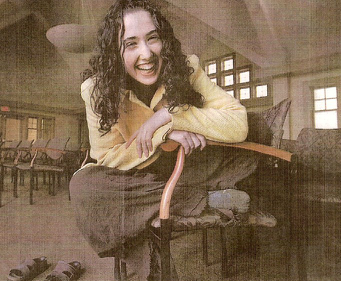 Image of Shulamit Izen sitting in a chair, laughing.