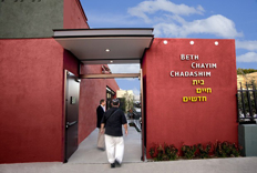 Image of a person entering Beth Chayim Chadashim Synagogue.
