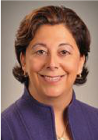 Image of Jennifer Gorovitz smiling at the camera. She is wearing a purple shirt.