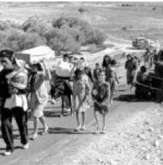 Black-and-white image of a group of people walking up a road.
