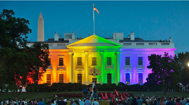 Image of the White House lit up in rainbow colors.