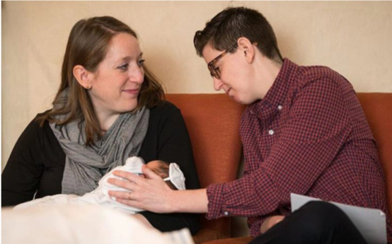 Image of Becca Israel and her wife holding their son.