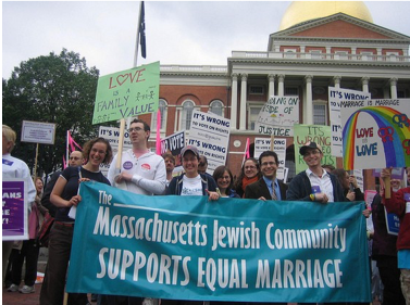 Image of a group of people with signs outside the Massachusetts State House. The largest banner reads: "The Massachusetts Jewish Community Supports Equal Marriage."