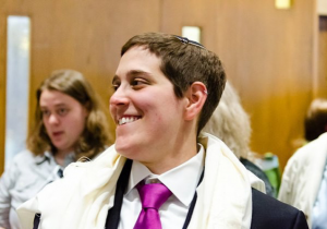 Image of Rabbi Becky Silverstein wearing a suit and a magenta tie.