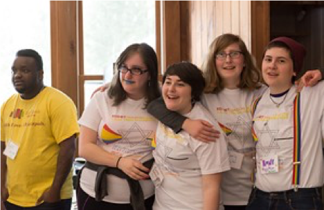 Image of a group of teens standing with their arms around each other, wearing matching shirts.