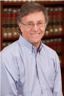 Image of Professor Ira Lupu smiling in front of a bookshelf.