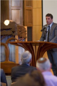 Image of Matan Zamir speaking in front of a podium.