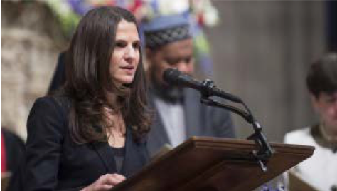 Image of Rabbi Sharon Brous speaking at a podium.