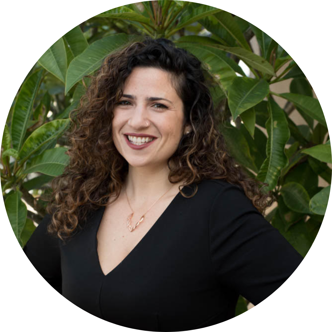 Woman with brown long brown curly hair smiling