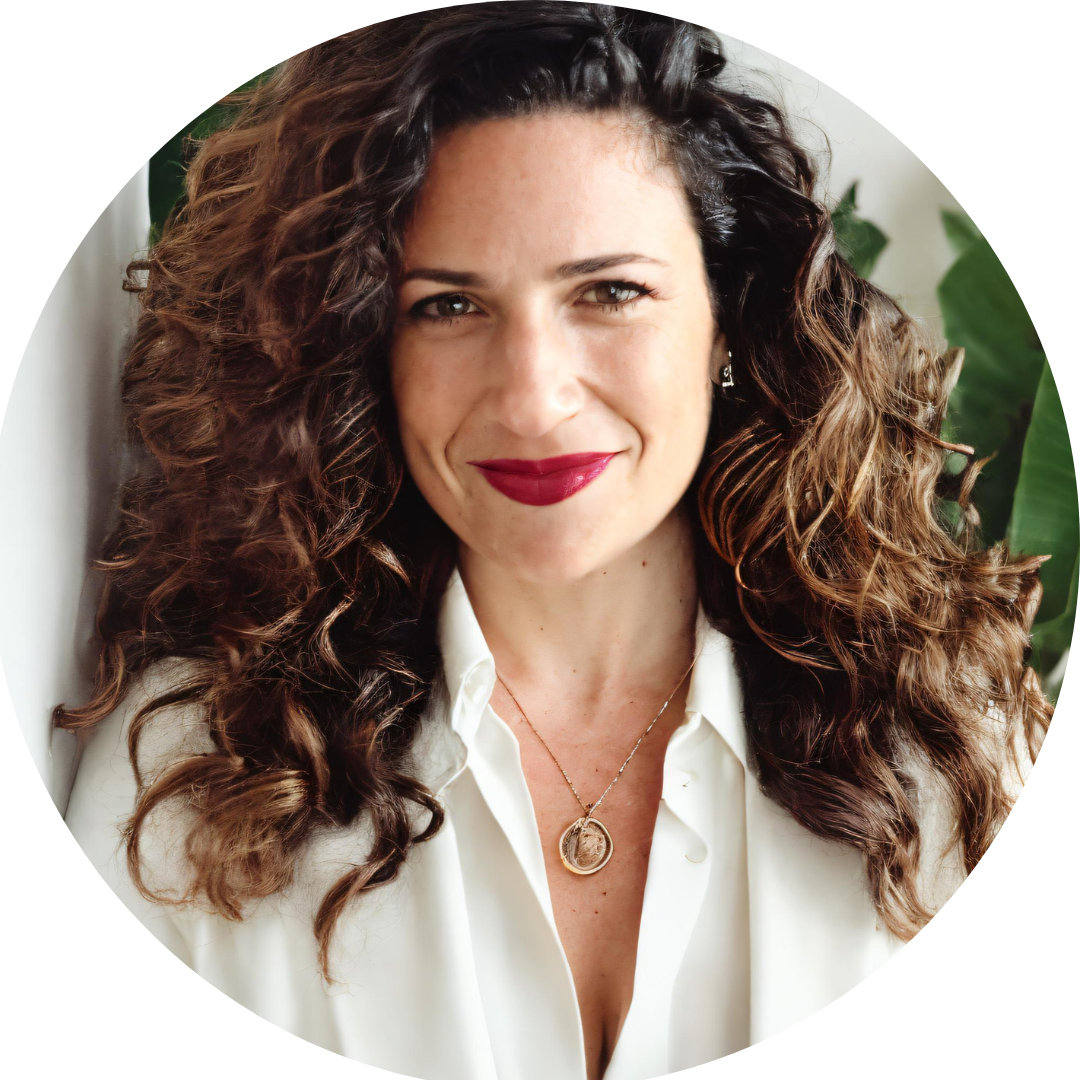 Woman with brown long brown curly hair smiling