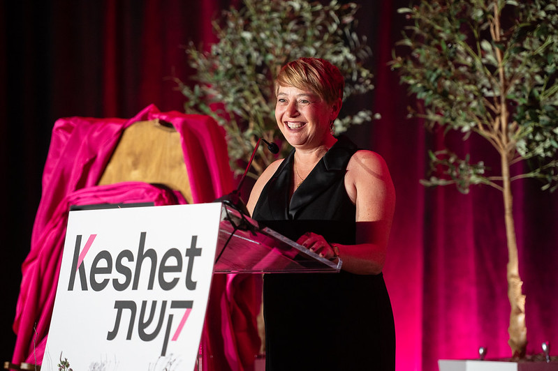Idit Klein smiling onstage at the XO gala
