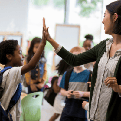 LGBTQ+ affirming school with smiling teacher and students